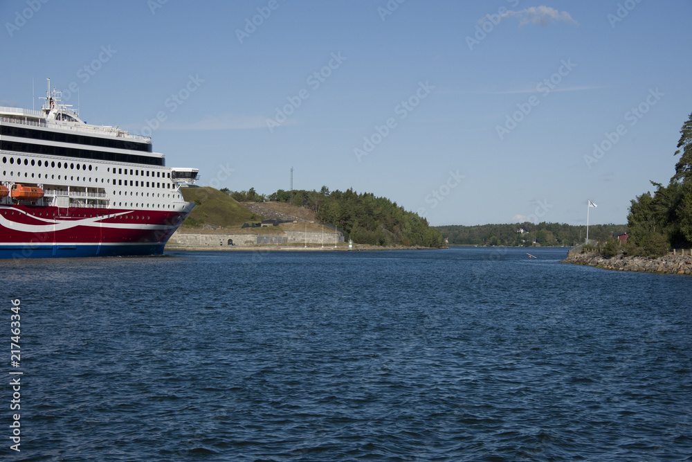 Ferry passes Oskar Fredriksborg at Rindö, Stockholm, Sweden Ferry passes Oskar Fredriksborg at Rindö, Stockholm, Sweden