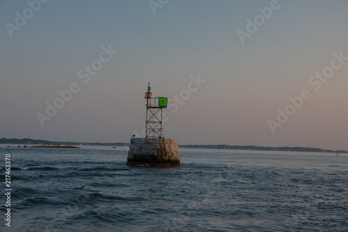 Sunset over entrance to harbor near Noank Connecticut photo