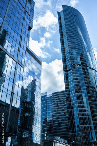 Detail blue glass building background with cloud sky