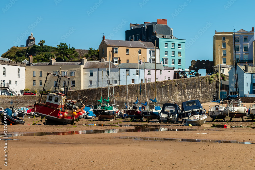 Picturesque harbor at low tide with boats resting on the sand waiting for the ocean to return