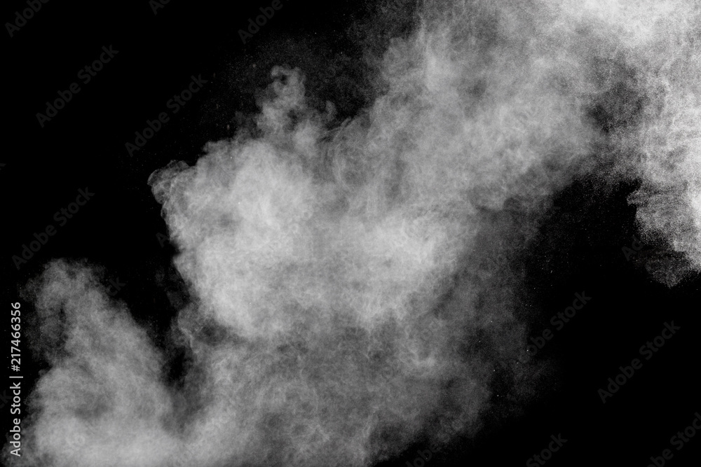 Fototapeta premium Bizarre forms of white powder explosion cloud against black background.