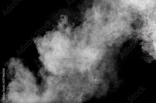 Bizarre forms of white powder explosion cloud against black background.