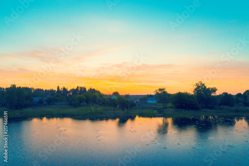 Village by the lake at sunrise