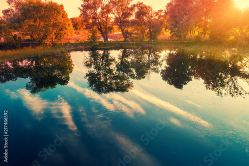View of calm lake with beautiful reflection in the evening