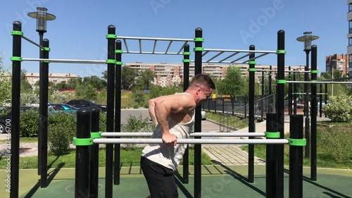 Wallpaper Mural Handsome sexy male bodybuilder athlete man doing crossfit workout in athletic facilities on sunny morning outdoors. Healthy lifestyle concept. Physical preparation of body motivation and energy charge Torontodigital.ca