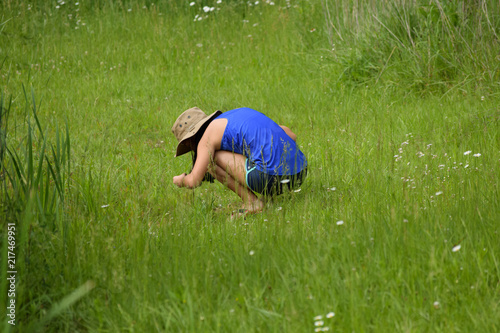 girl exploring outdoors in summer grass