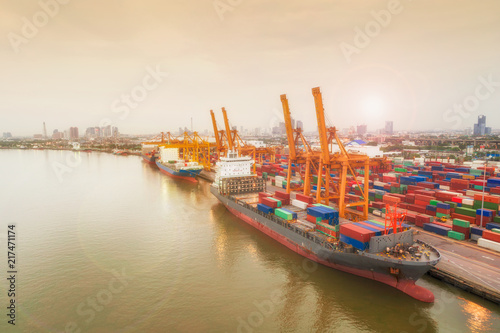 Aerial view of ship containers at shipping port for international import or export logistics or transportation business concept background.