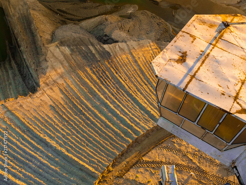 top view of the sand pit. photo from a career tractor. yellow sand at sunset. sand with drawings. picture for the background. tractor tracks photo