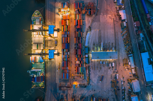 Aerial top view of ship containers at shipping port for international import or export logistics or transportation business concept background.