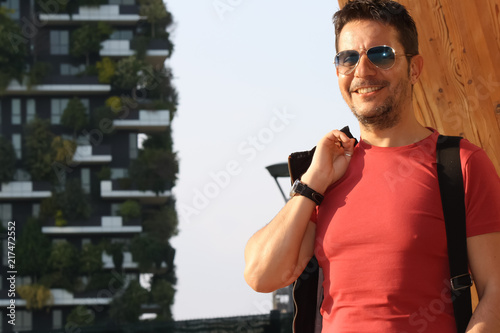 Italy, milan, gae aulenti. Portait of man with backpack photo