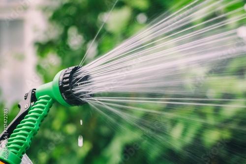Garden sprinkler for irrigation plants with jets of water. Frozen motion
