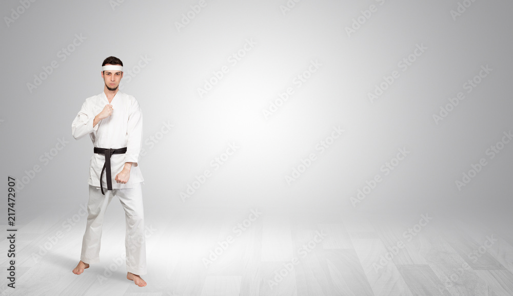 Young kung-fu trainer fighting in an empty space
Young kung-fu trainer fighting in an empty space