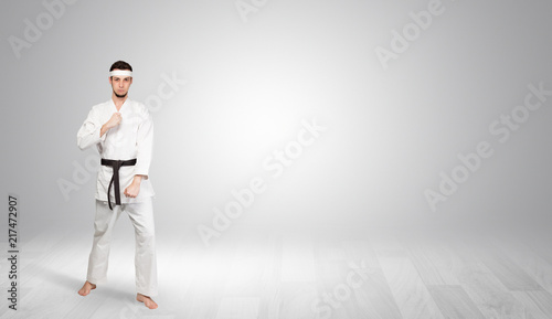 Young kung-fu trainer fighting in an empty space 