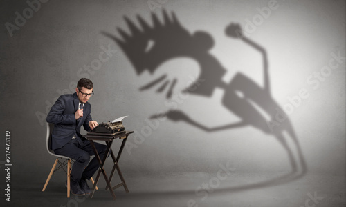 Man working hard and he is afraid of a yelling shadow
 photo