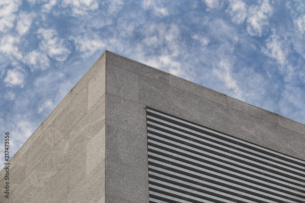 From below corner of modern urban building with striped gird. From below corner of modern urban building with striped gird.