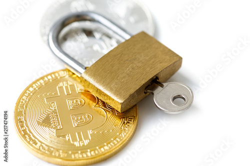 Bitcoin coins and padlock on white background photo