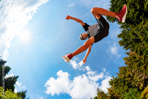 Принти на полотні Boy makes a jump in a mountain meadow
