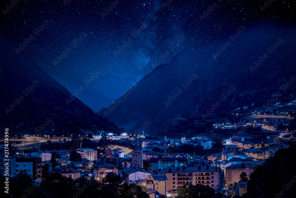 Fototapeta premium Mountain village under Milky Way night sky