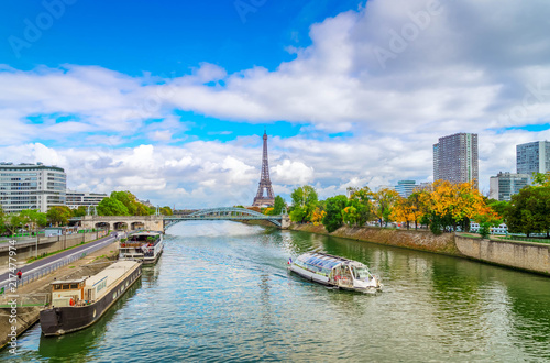 view of Eiffel Tower with moden houses over Seine at fall, Paris, France