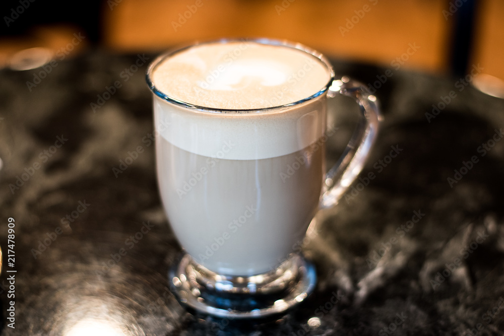 Milky Latte In Glass Mug On Dark Table At Diner