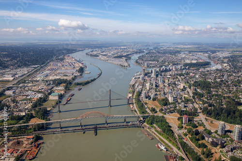 Aerial city view of Pattullo and Skytrain Bridge across the Fraser River. Taken in Greater Vancouver, British Columbia, Canada.