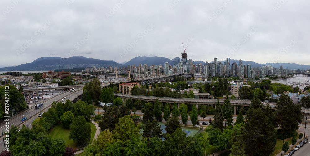 Aerial panoramic view of Downtown City during a cloudy summer evening before sunset. Taken in Vancouver, British Columbia, Canada.