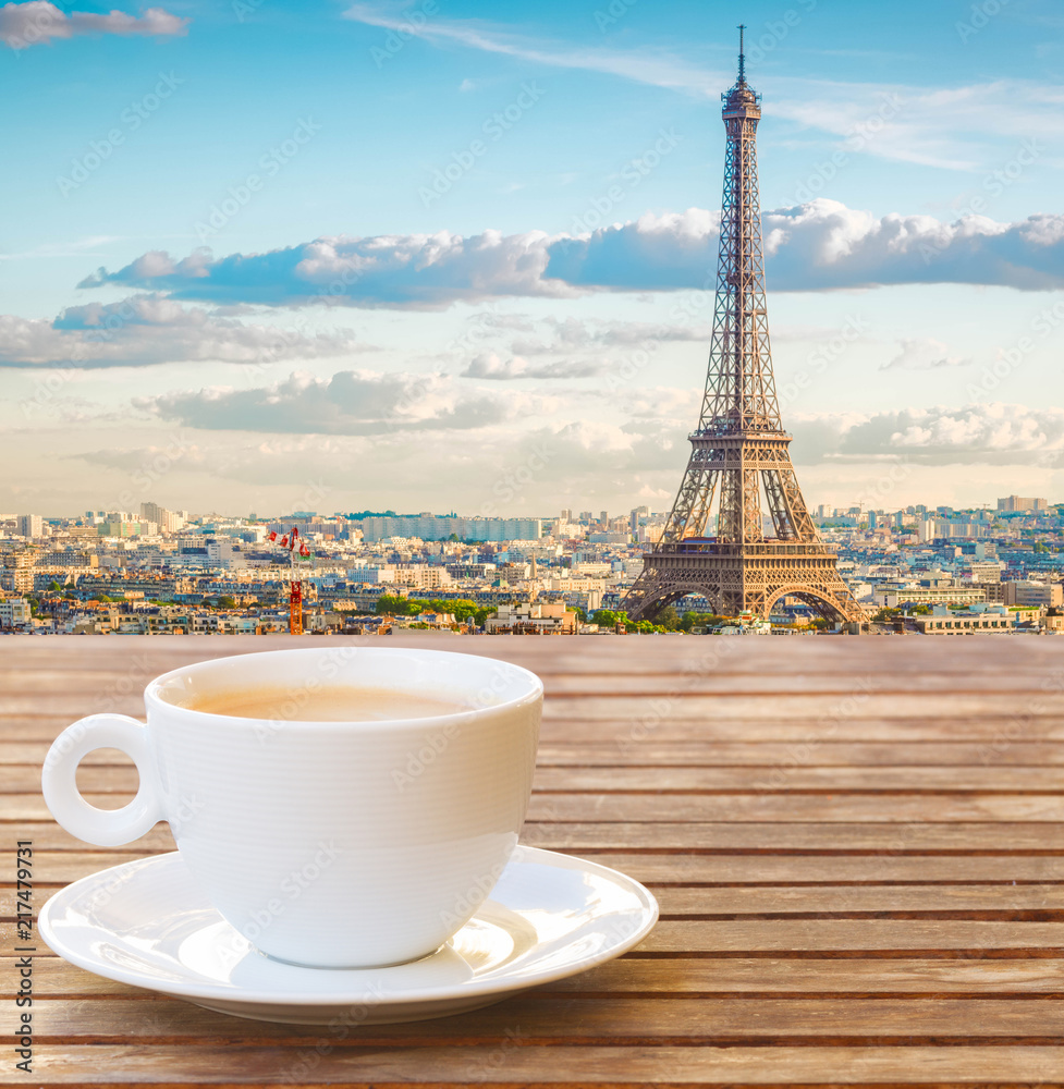cup of coffee with view of famous Eiffel Tower landmark and Paris old