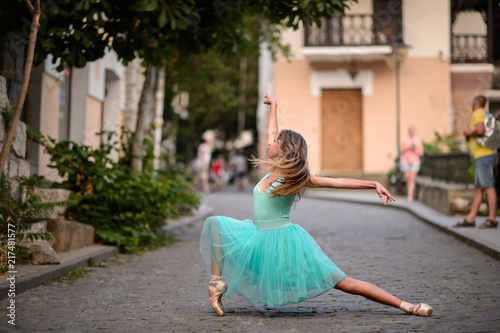 Elegant ballet dancer girl dancing ballet in the city photo