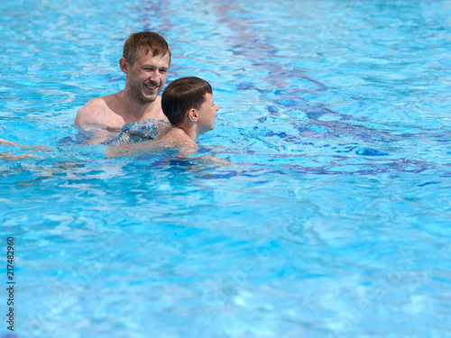 Father is teaching his son to swim. © Artem