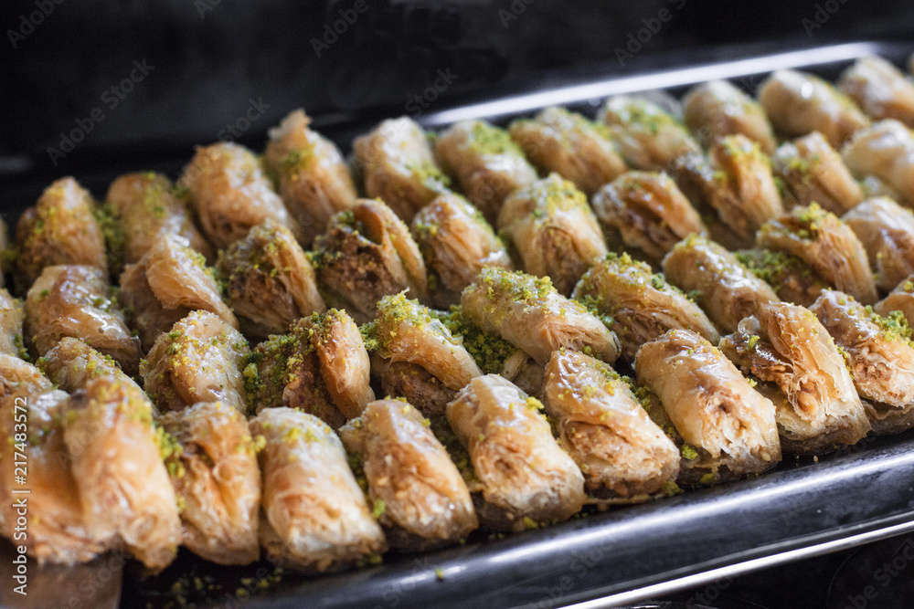Traditional Turkish dessert - baklava with pistachios on a tray Traditional Turkish dessert - baklava with pistachios on a tray