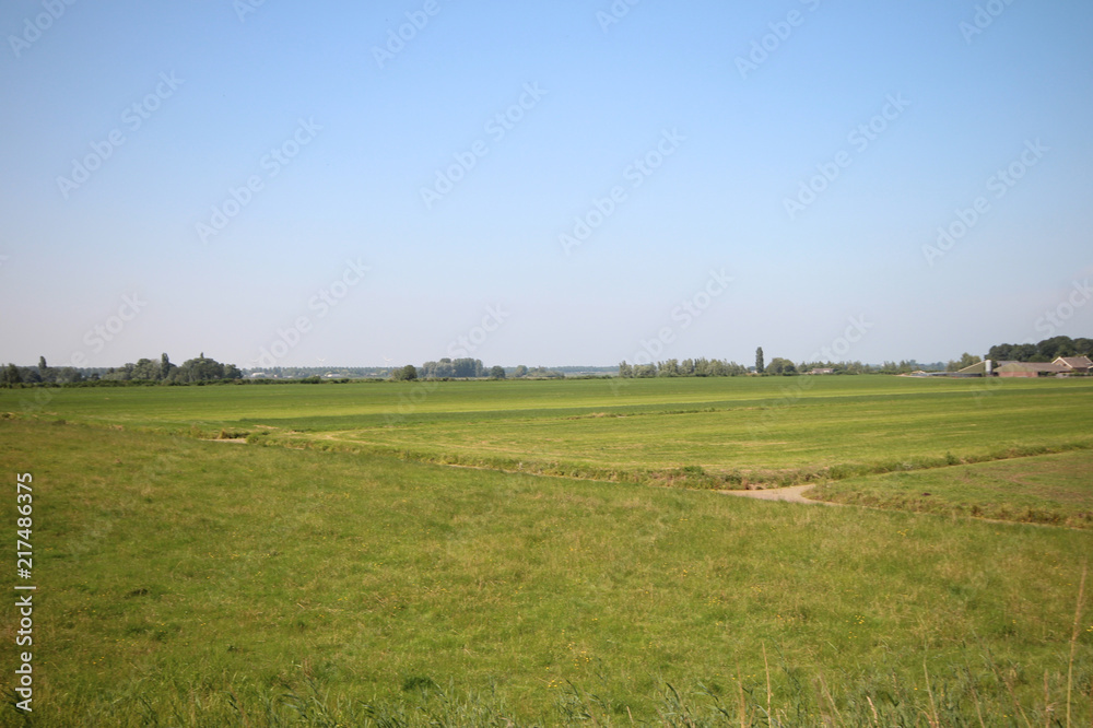 Fields, roads,bicycle lanes and canals along the dyke of the Hollandsche IJssel in Moordrecht, the Netherlands/