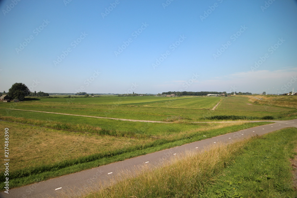 Fields, roads,bicycle lanes and canals along the dyke of the Hollandsche IJssel in Moordrecht, the Netherlands/ Fields, roads,bicycle lanes and canals along the dyke of the Hollandsche IJssel in Moordrecht, the Netherlands/