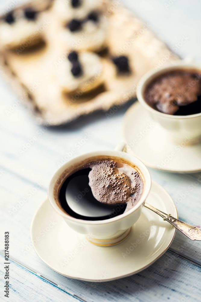 Cup of coffee with tasty cakes on table. Cup of coffee with tasty cakes on table.