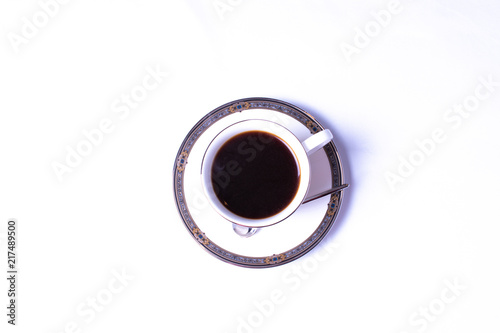 Coffee In A Formal China Cup On A Saucer With Spoon On A White Background
