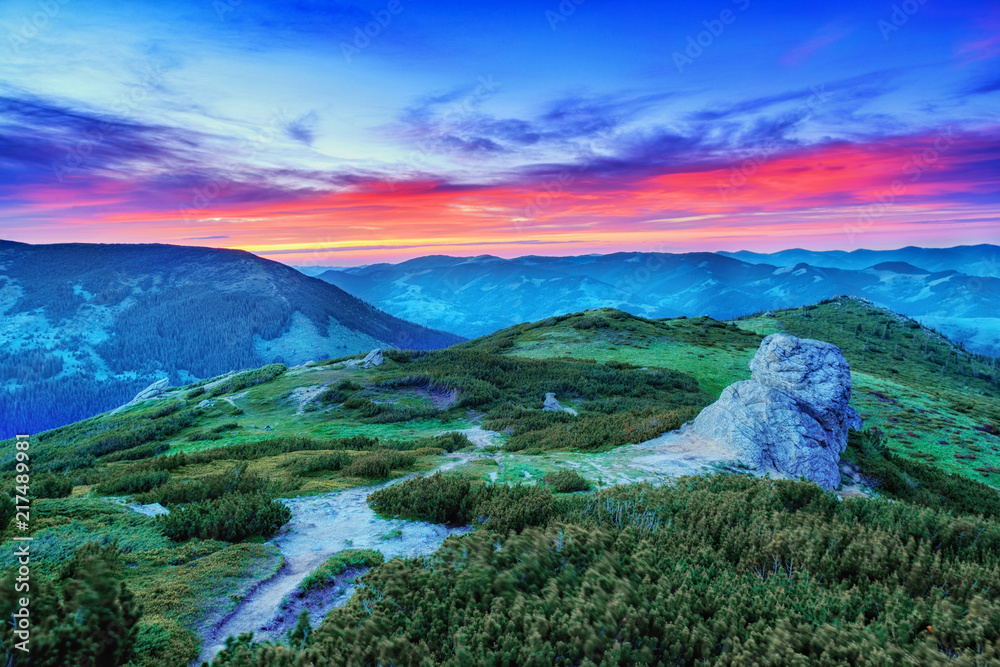 Captivating mountain landscape, sunrise scenery. Stunning colorful epic sky above. Lilac, yellow, green and red colors in nature. Ukrainian Carpathians - Alpine system.