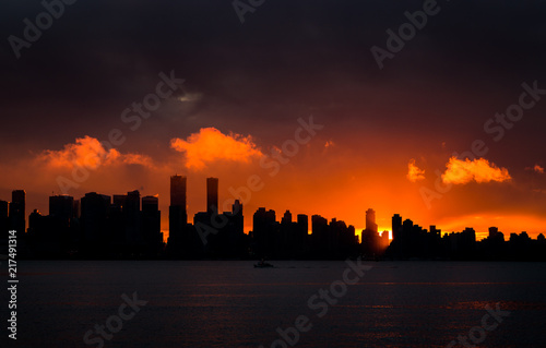 Downtown Vancouver silhouetted against the setting sun.