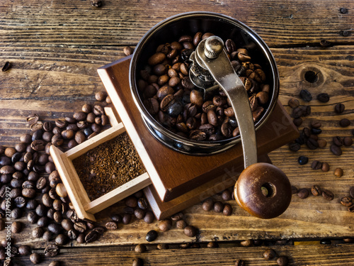 Wooden coffee grinder with ground coffee