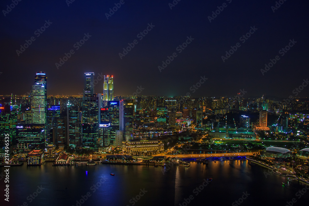 SINGAPORE, January 19 2014 - Singapore Skyline at Night viewed from Ku De Ta Restaurant in Marina Bay Sands hotel