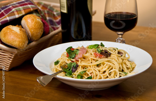 Pasta dinner with bread and wine
