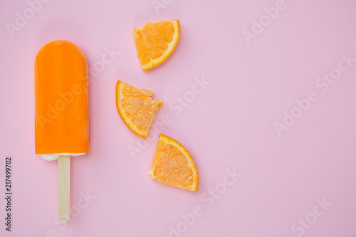 Popsicle with fresh orange on a table photo