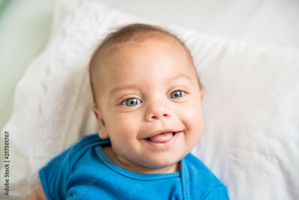 Blue eyed baby boy lying in crib - Lifestyle Blue eyed baby boy lying in crib - Lifestyle