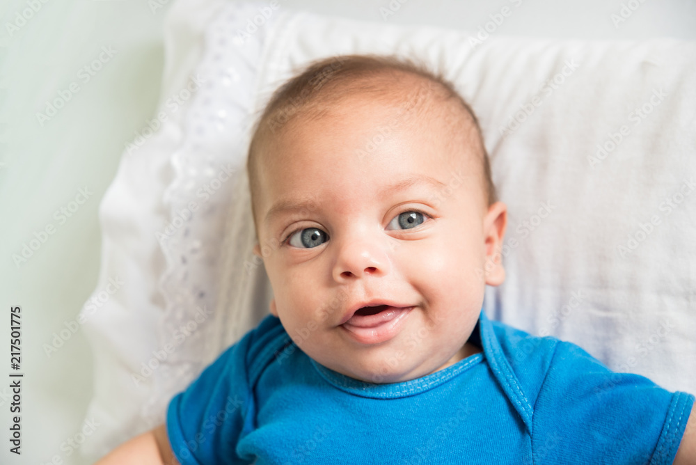 Blue eyed baby boy lying in crib - Lifestyle Blue eyed baby boy lying in crib - Lifestyle