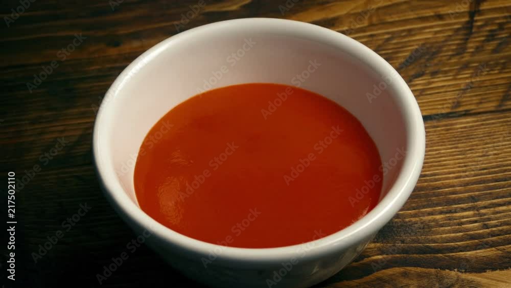 Pot Of Soup Poured Into Bowl On Table Pot Of Soup Poured Into Bowl On Table