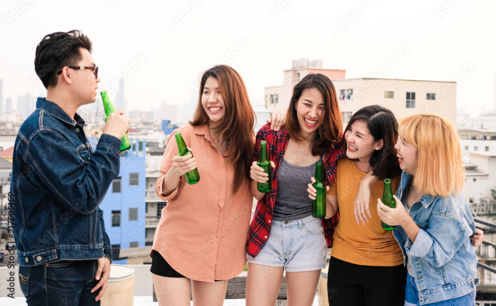 Fototapeta premium Group of asian women and man drinking at rooftop party, casual outdoors celebration