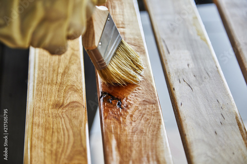 Paint Brush in a can of varnish in preparation to stain the wood slats photo