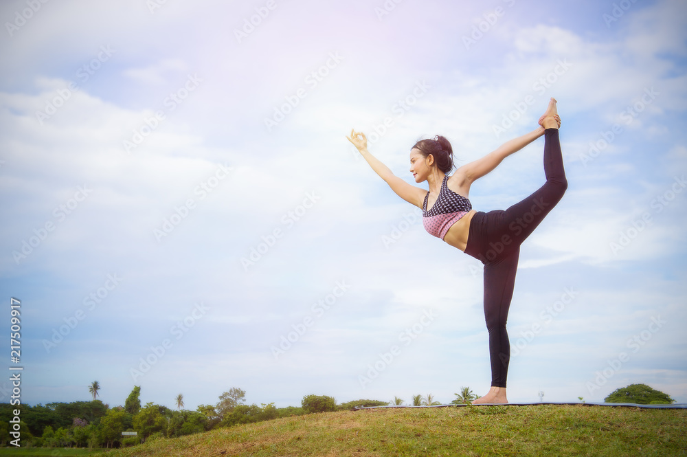 yoga girl In the morning time on blue sky background Strengthen the concentration of skin, health and good health is a good exercise