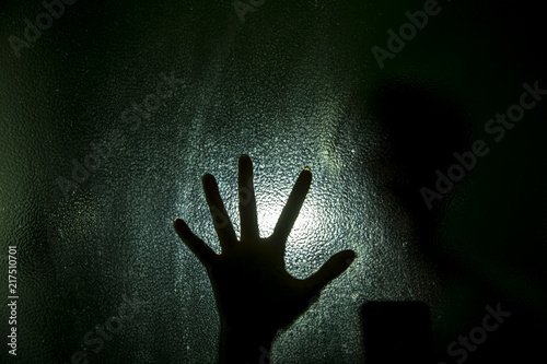 Silhouette of hand with glass