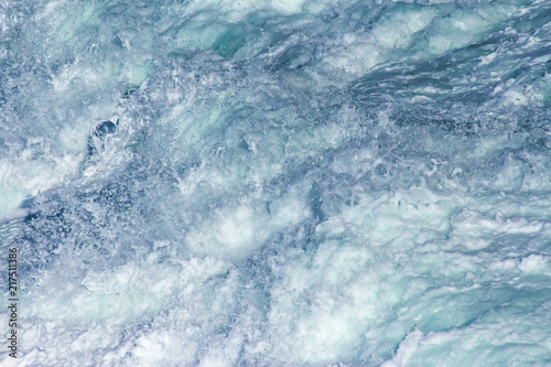 Aquatic background of sea surf waves close up with clear water and white foam