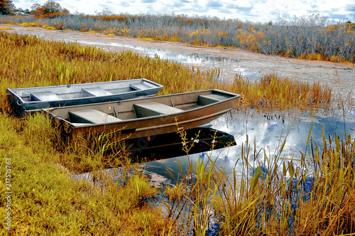 boats on a river shore autumn in the swamps photo