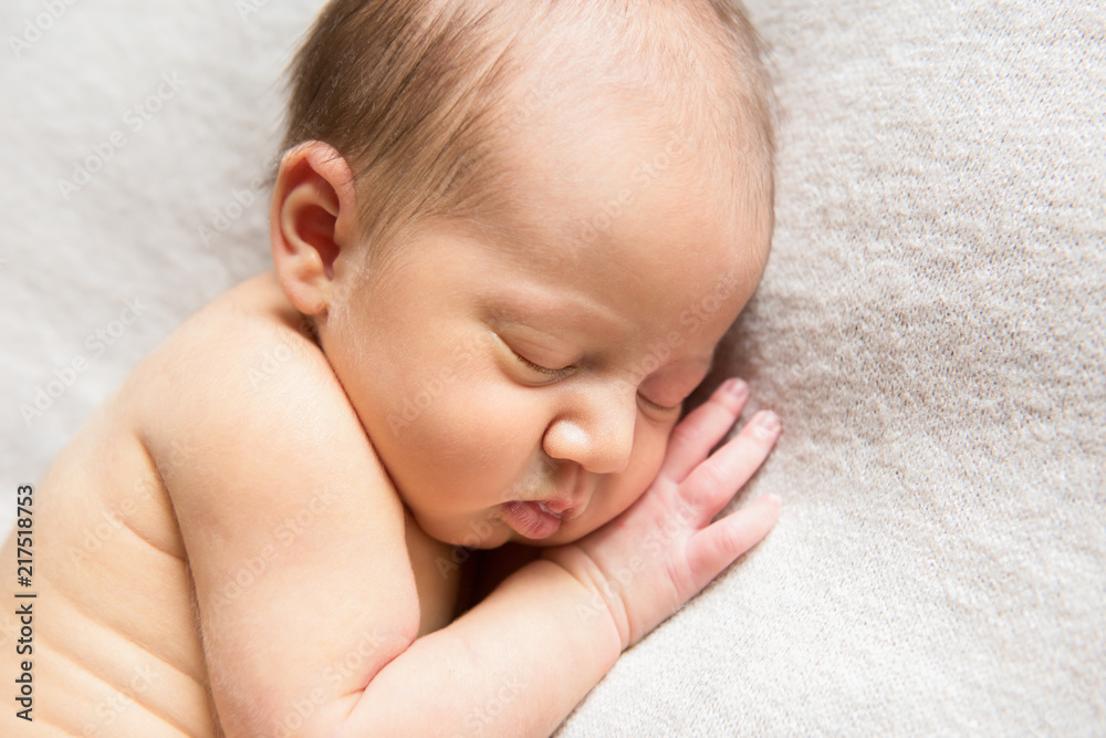 Newborn sleeping with his hand under the cheek Newborn sleeping with his hand under the cheek